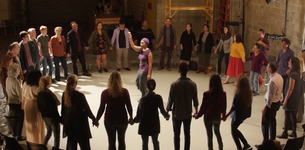 Gallery image of Onome leading a singing circle for BlesSING at Target Margin: Doxsee Theater.